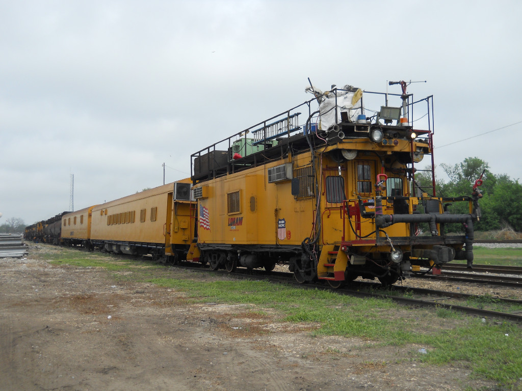 LMIX 315  1Apr2011  Support Car on the back of Loram Rail Grinder Train (RG 15) in the yard 